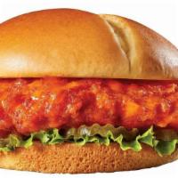 Fire It Up Chicken Burger · A golden-fried chicken breast tossed in buffalo sauce with lettuce and pickles on a split to...