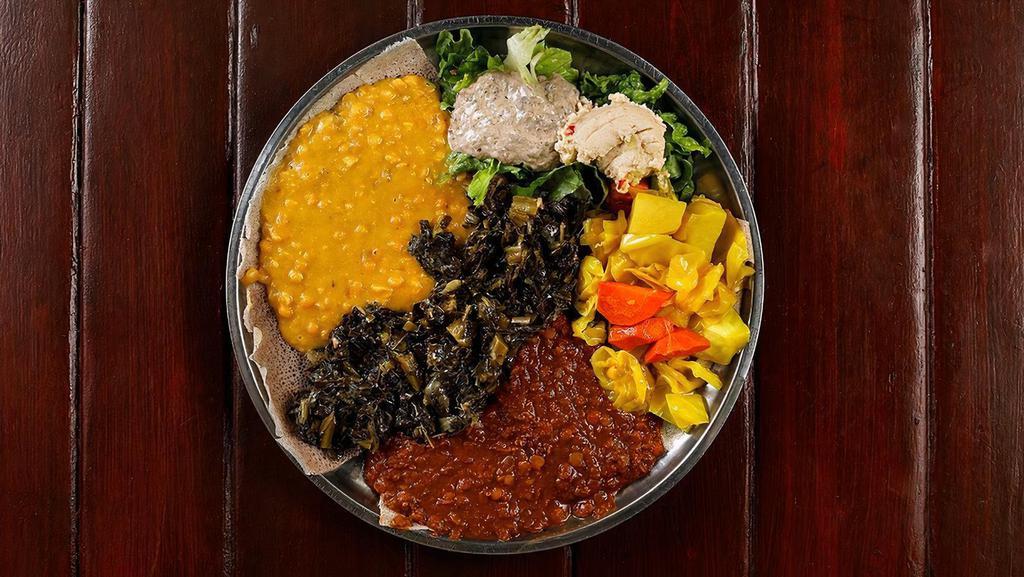 Vegan Combination Platter (VG) · A Cafe Colucci favorite — our Vegan Combination Platter. . Enjoy all things wholesome with a vegan feast featuring staples in traditional Ethiopian cuisine including Azifa, Buticha, Messer Wot, Kik Alicha, Gomen and Atakilt. . Served with “salata” (salad) and a whole injera. . Choose from our House injera or a yummy Gluten Free teff injera. . Order Extra Injera under 