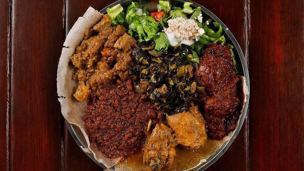Meat Combination Platter · A carnivorous feast for true meat lovers! This combination platter is overflowing with some of our favorite meaty dishes — Doro Wot, Doro Alicha, Sega Alicha, Minchet Abish Wot and Gomen. . Served with a side of “ayeb” (Ethiopian cheese) “salata” (salad), sour cream, and a whole injera. ****Find this recipe at Brundo.com!****. ===All Spices and Herbs are from Brundo Spice Company and available online at brundo.com ===