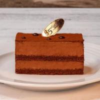 Deluxe Chocolate Mousse | Slice · Chocolate mousse and chocolate chiffon cake covered with cocoa powder.