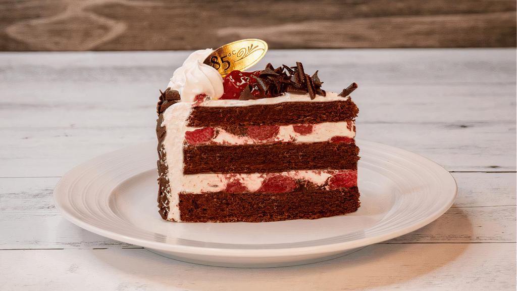 Black Forest | Slice · Chocolate sponge cake with sweet cherries, fresh cream, and decorative chocolate shavings on top.