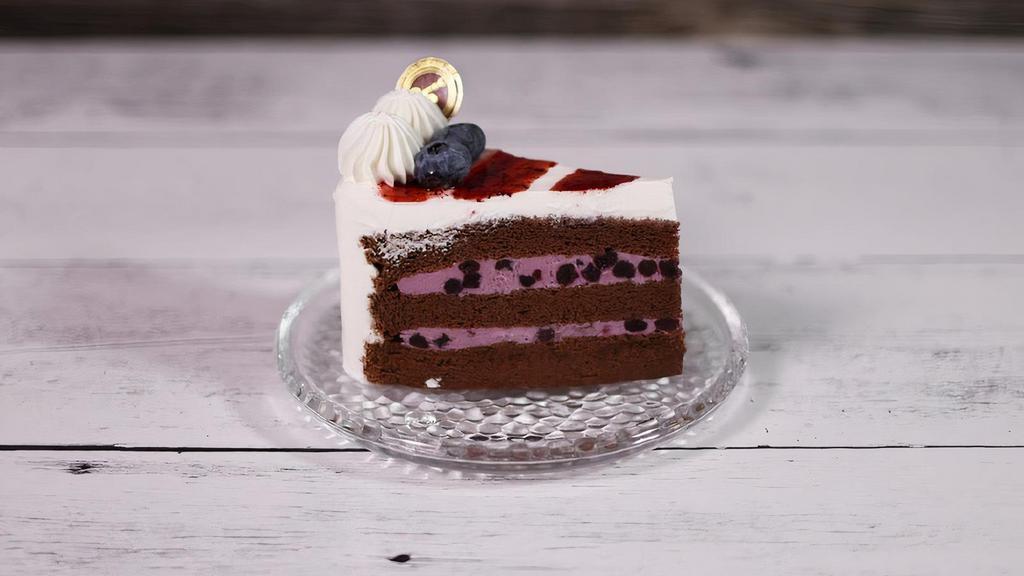 Blueberry Cream | Slice · Light chocolate cake layered with sweet blueberry cream. Decorated with soft cream and fresh blueberries