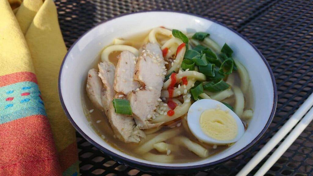 Chicken Udon Soup · Japanese-style soup, prepared with Udon (thick flour noodles), Chicken, green onions, seaweed, sesame seed, and mixed vegetables.
