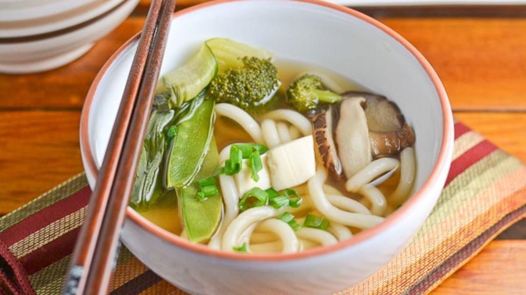 Vegetable Udon Soup · Japanese-style soup, prepared with Udon (thick flour noodles), fresh vegetables, house seasoning, green onions, seaweed, sesame seed, and mixed vegetables.
