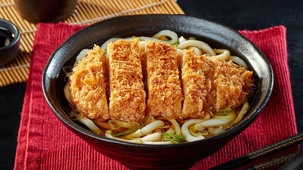 Ton Katsu (Pork) Udon Soup · Japanese-style soup, prepared with Udon (thick flour noodles), Breaded deep-fried Pork, green onions, seaweed, sesame seed, and mixed vegetables.