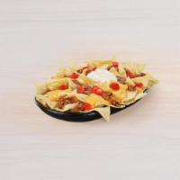 Nachos Bellgrande® · A portion of crispy tortilla chips topped with warm nacho cheese sauce, refried beans, seaso...