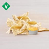 Chips And Nacho Cheese Sauce · Nacho chips with a side of warm nacho cheese sauce for dipping.