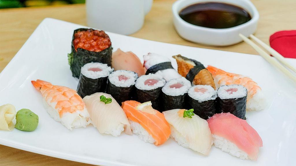 Sushi* Deluxe · Tuna Roll served with a piece of tuna, salmon, salmon roe, snapper, eel, yellowtail, shrimp, albacore and octopus nigiri.