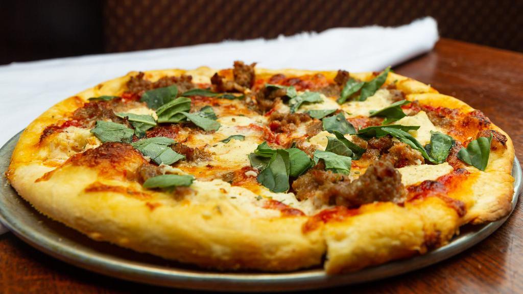 Salsiccia Pizza · All natural garlic fennel sausage, herbed ricotta, basil, mozzarella, and homemade tomato sauce. Light and crispy, Italian thin crust made with extra fine 