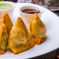Vegetable Samosa (2) · Two pieces of samosas made with a special dough, stuffed with potatoes and peas. served with...