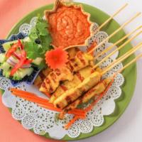 Chicken Satay (6) · Strips of chicken on skewers marinated in coconut milk and curry powder, grilled served with...