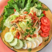 Thai Salad · Fresh green lettuce with tomatoes, cucumbers, egg, red onions and bell peppers served with p...