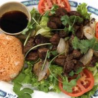 Com Bo Luc Lac · Cube Steak over Red Rice