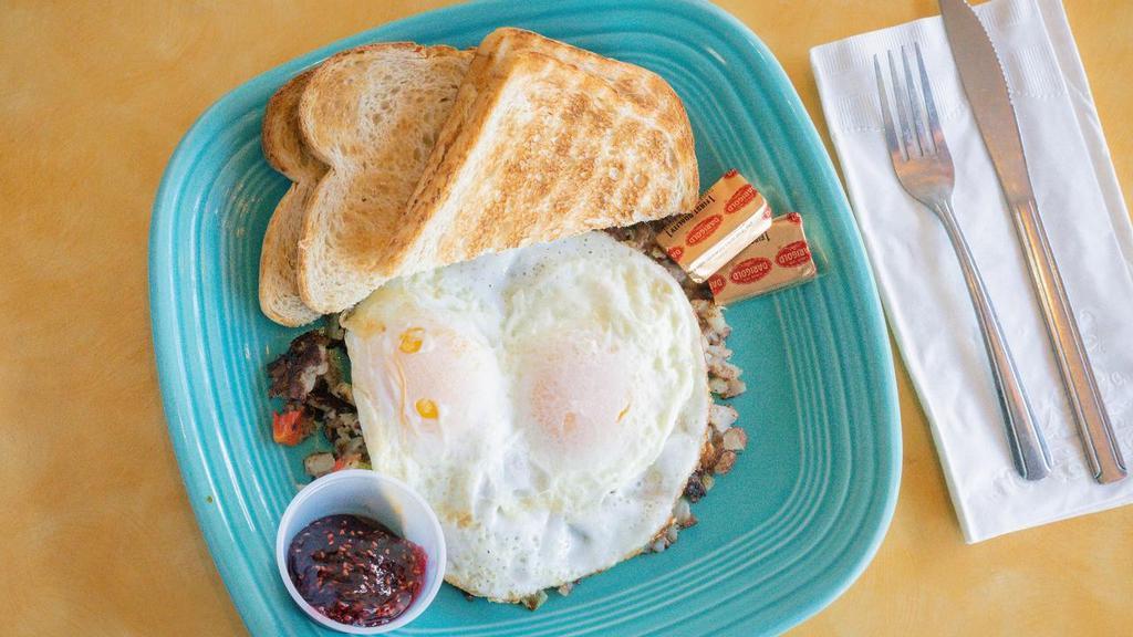Corned Beef Hash · Our hand-made hash, from corned beef, potato, onion, green & red bell pepper. Topped with 2 eggs over easy and served with toast.