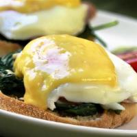 Eggs Florentine · Two poached eggs over English muffin with spinach. Served home fries and hollandaise sauce.