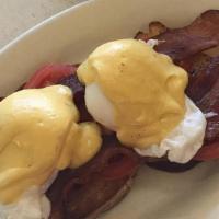Eggs Blackstone · Two poached eggs over English muffin with bacon and tomatoes. Served home fries and hollanda...