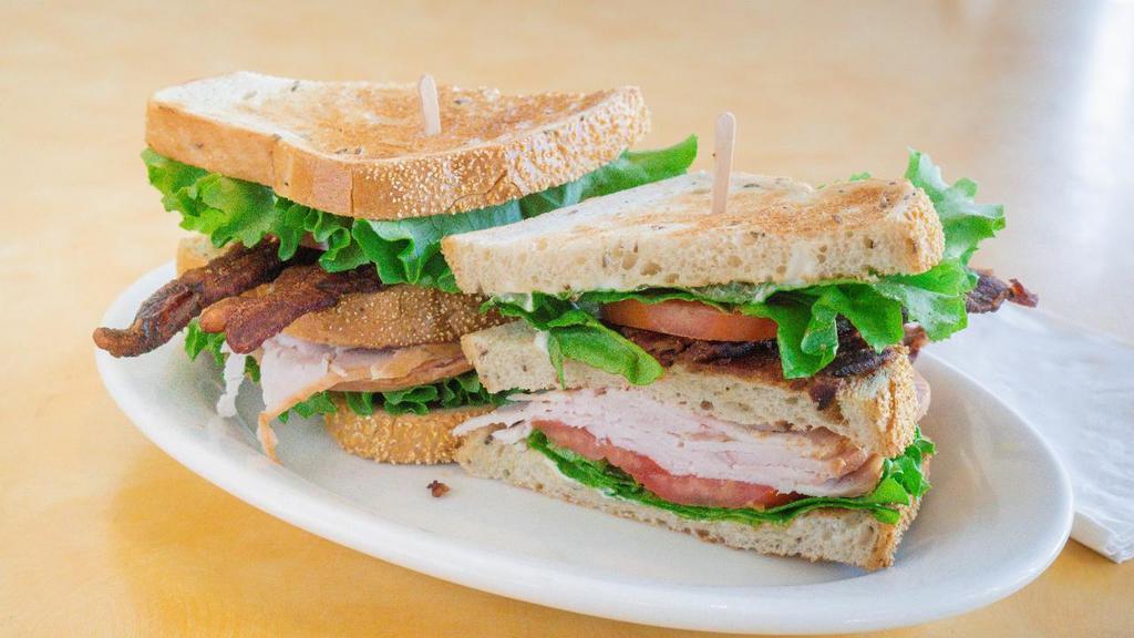 Turkey Club · Classic club sandwich with turkey, bacon, lettuce and tomato on rye.