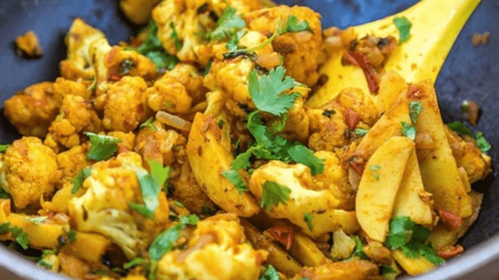Aloo Gobi (Vegan) · Popular Indian dish fresh cauliflower and potato cooked with onions, tomatoes and spices.