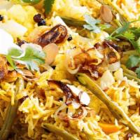 Veggie Briyani (Vegan) · Saffron flavored basmati rice with vegetables and nuts.