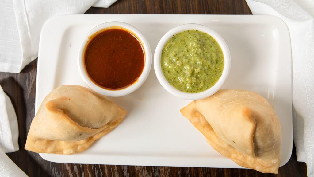 Vegetable Samosa (2 pieces) · Pastry with vegetable stuffing.