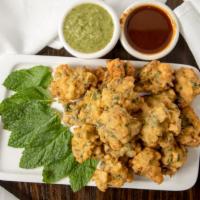 Mixed Vegetable Pakoras · Vegetables dipped in chickpea batter and deep-fried.