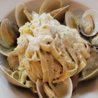 Fettuccine alle Vongole · House made fettuccine, manila clams and garlic with spicy tomato or white wine sauce.