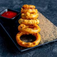 Onion Bhaji/Onion Rings · Onion rings battered with a subtle blend of spices and made crunchy.