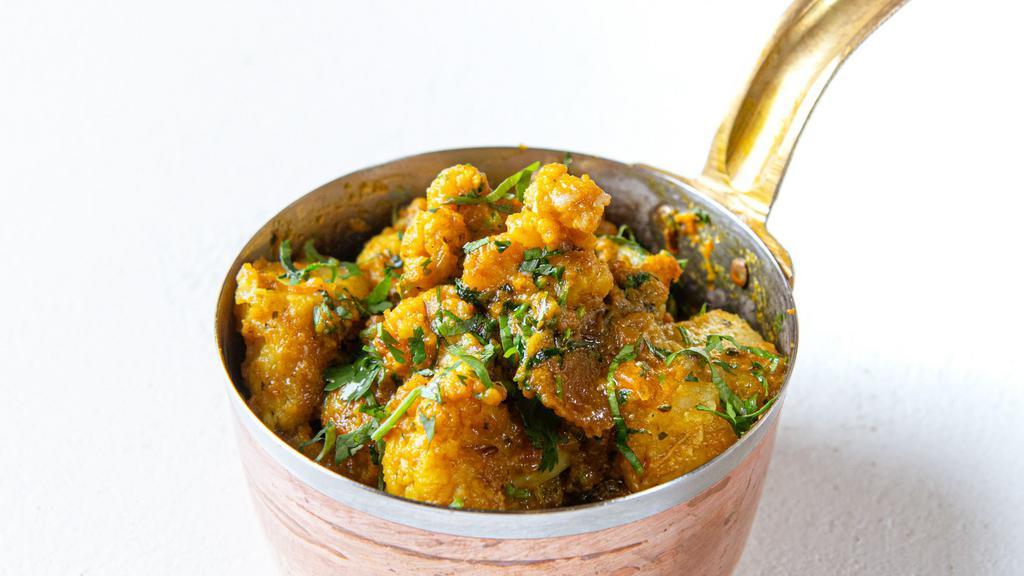 Aloo Gobi Methiwala · Onion kadai masala and methi tossed with potato and cauliflower.