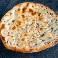 Kulcha · Indian flatbread stuffed with chat onion and cooked in a tandoor.