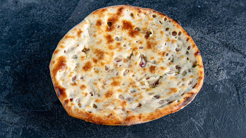 Kulcha · Indian flat bread stuffed with chat onion  and cooked in a tandoor.