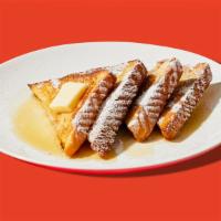 Classic French Toast · Two slices of egg-washed french toast topped with maple syrup and butter.