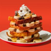 Chocolate Chip Banana French Toast · Two slices of egg-washed french toast topped with banana, chcocolate chips, whipped cream, m...
