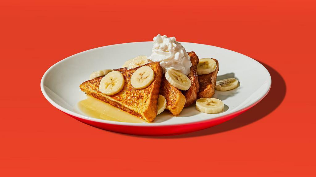 Banana French Toast · Two slices of egg-washed french toasttopped with banana, whipped cream, maple syrup and butter.