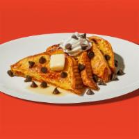 Chocolate Chip French Toast · Two slices of egg-washed french toast topped with whipped cream, chocolate chips, maple syru...