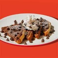 Chocolate Chip Nutella French Toast · Two slices of egg-washed french toast topped with nutella, chocolate chips, whipped cream, m...