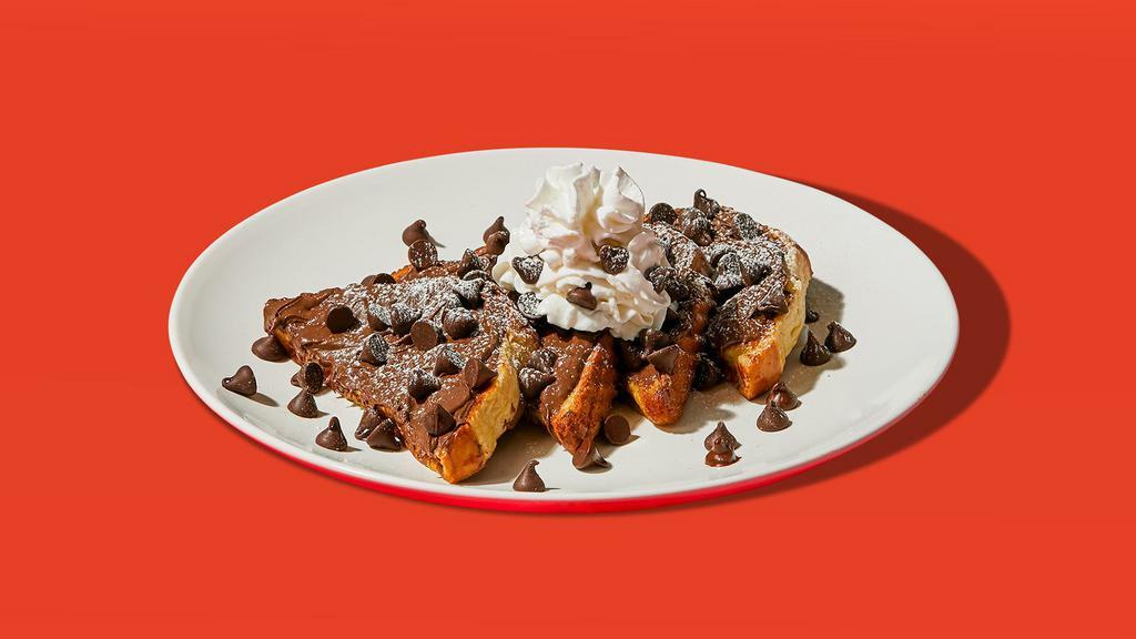 Chocolate Chip Nutella French Toast · Two slices of egg-washed french toast topped with nutella, chocolate chips, whipped cream, maple syrup and butter.