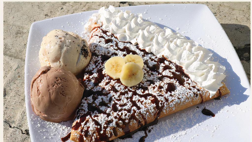 Nutella crepe with banana & strawberry  · Crepe with Nutella, banana & strawberry inside. Chocolate drizzle and powder sugar on top with whipped  cream.