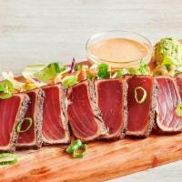 Seared Pepper Ahi* · Seared rare with garlic pepper seasoning. Served with a creamy ginger soy sauce and wasabi.