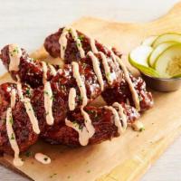 Aussie Twisted Ribs · Our tender St. Louis Ribs fried Outback-style then tossed in tangy BBQ sauce and drizzled wi...