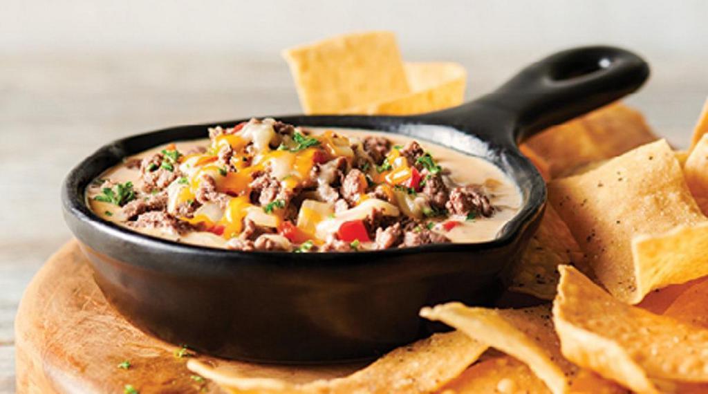 Three Cheese Steak Dip · Blend of steak, Gouda, Parmesan and Jack cheeses, red bell peppers and onions. Served with tortilla chips for dipping.