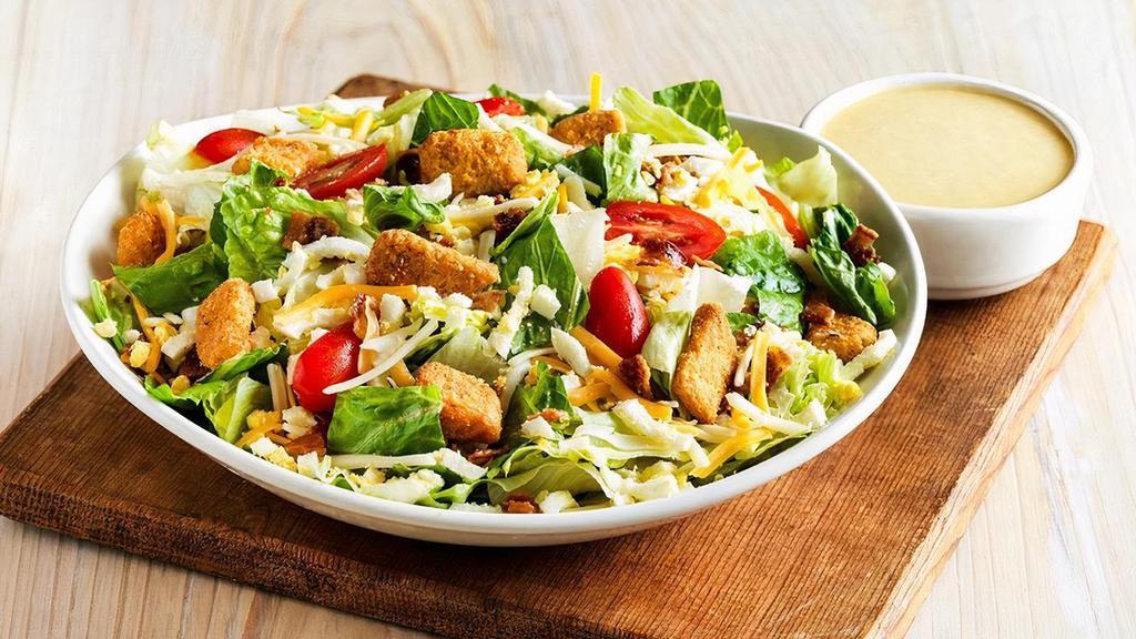 Aussie Cobb Salad · Fresh mixed greens, chopped hard-boiled eggs, tomatoes, bacon, Monterey Jack and Cheddar cheese and croutons. Served with your choice of dressing.