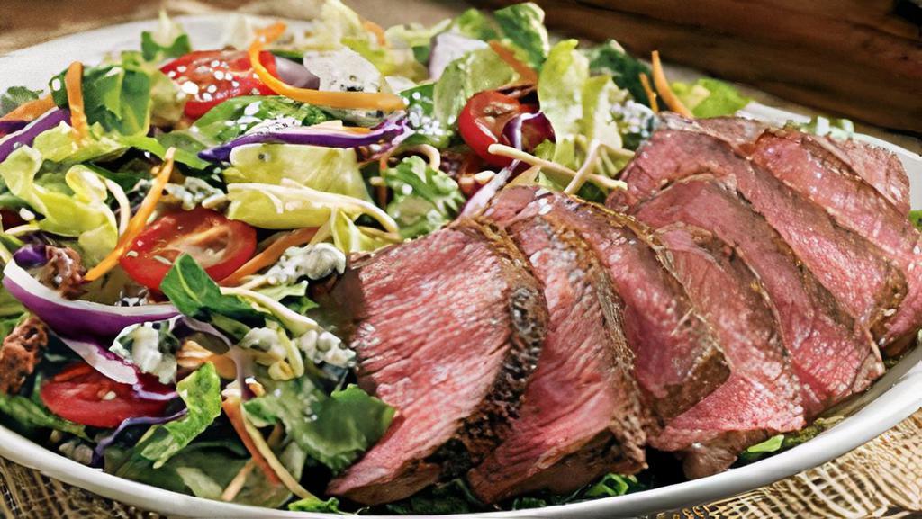 Steakhouse Salad* · Seared center-cut sirloin, mixed greens, Aussie Crunch, tomatoes, red onions, green onions, cinnamon pecans, Blue Cheese crumbles and our Danish Blue Cheese vinaigrette.