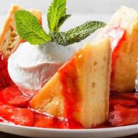 Butter Cake · Sweet and rich butter cake topped with strawberries and house-made whipped cream.