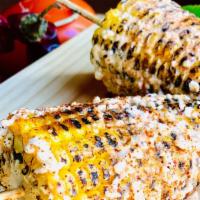 Elotes · Grilled corn served mexican street-style! Coated in crema mexicana, queso fresco, salsa vale...