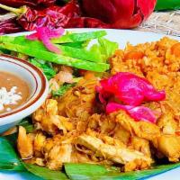 Pollo Pibil De Yucatan · Tender slow-cooked chicken, marinated in a citrus achiote blend, served w/ rice & refried be...