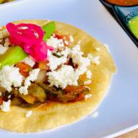Taco - SINGLE · Handmade corn tortilla, refried beans, queso fresco, crema, avocado slices, and pico de gallo.