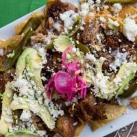 Super Nachos · Our super nachos are BIG and come with everything on them:

-Melted cheese
-Queso Fresco  
-...