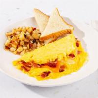 Chicken Bacon Cheese Omelette · Three eggs scrambled with cheese and crispy chicken bacon bits. Served with home fries and t...