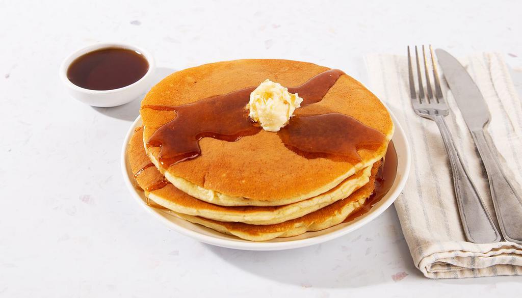 Buttermilk Pancakes · Two fluffy buttermilk pancakes served with maple syrup and powdered sugar.