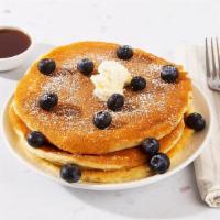 Blueberry Pancakes · Two fluffy buttermilk pancakes topped with fresh blueberries, and served with maple syrup an...